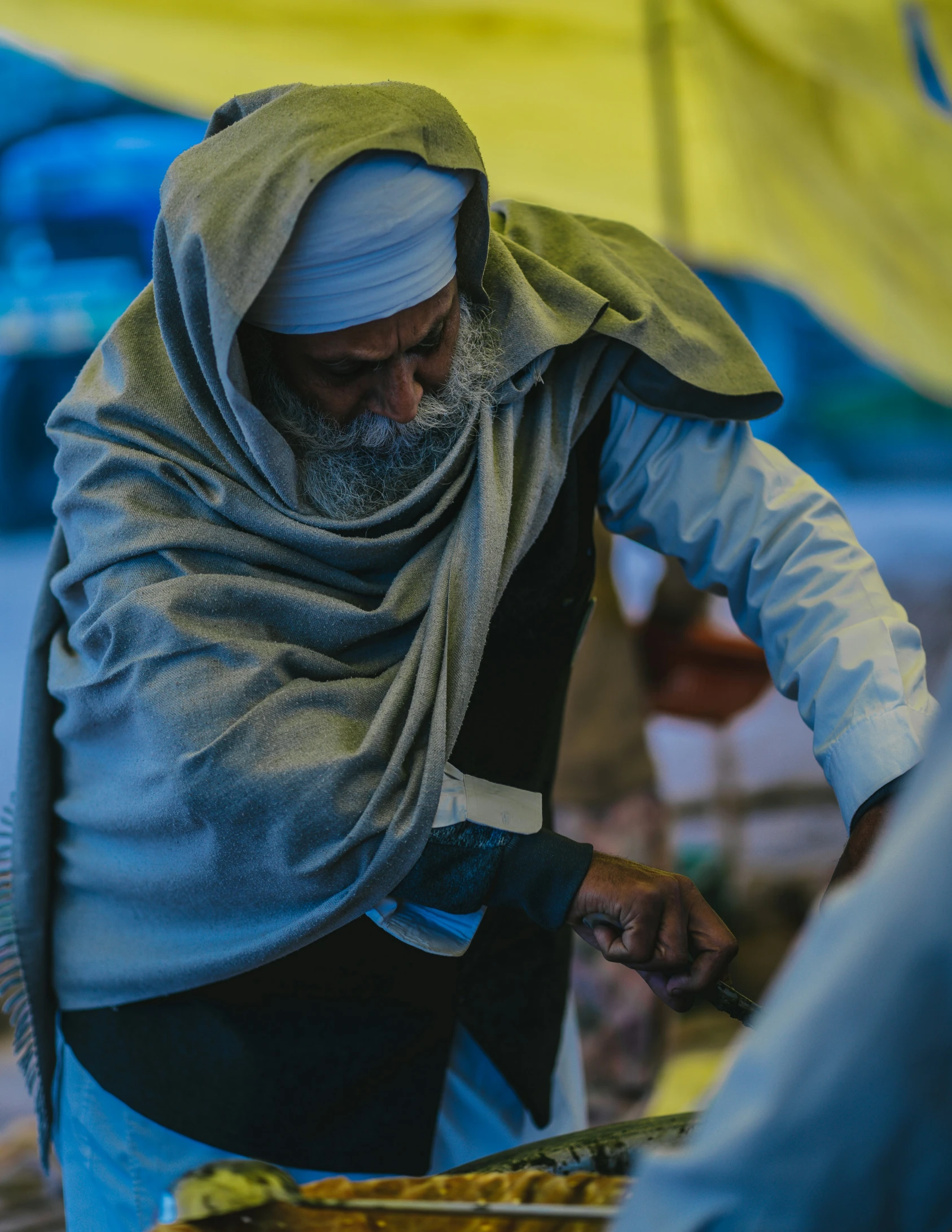 an older man preparing food on a table