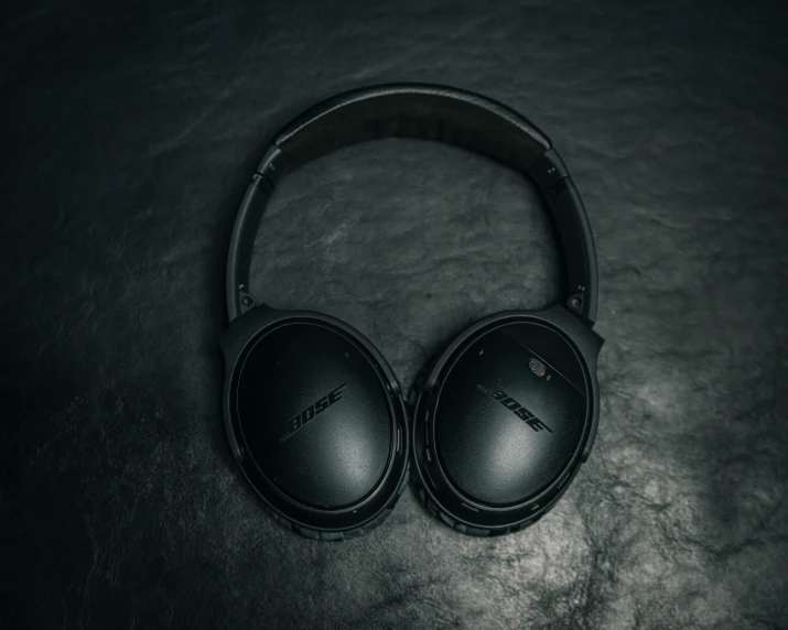 a pair of headphones sit on a black table