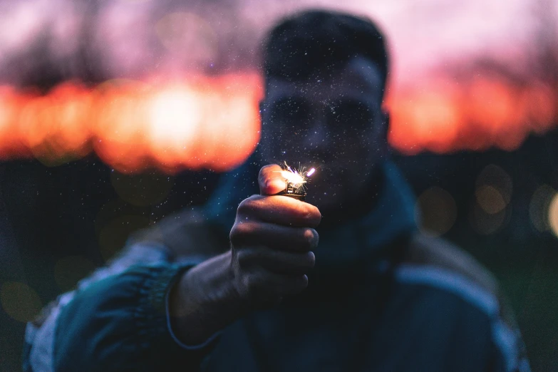 man with a cigarette standing outside at night