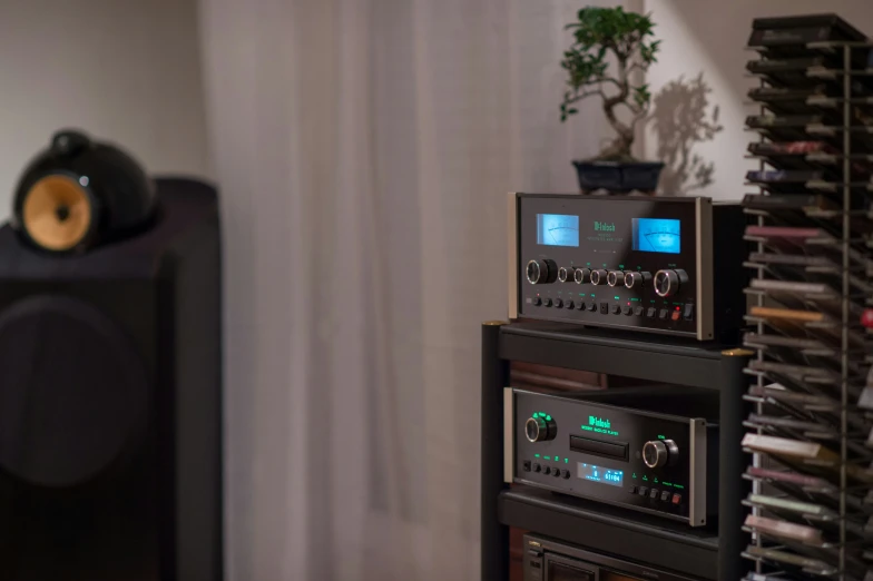 stereo equipment sits inside of a room next to some books