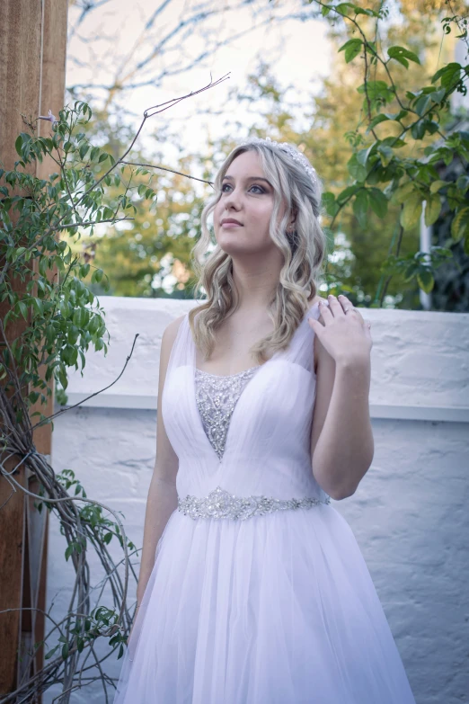 a pretty woman in a white dress posing