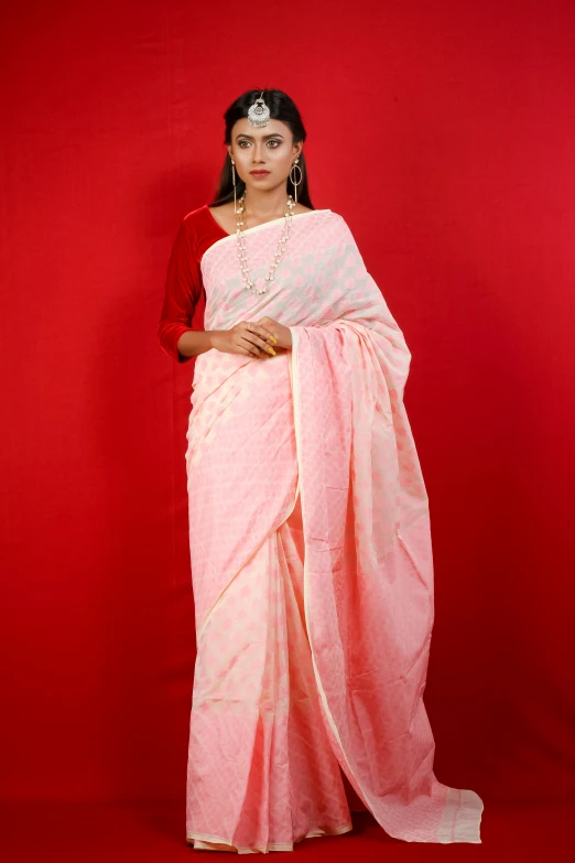 an indian woman in red and white attire