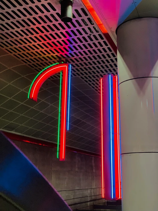 red, green and yellow neon lights on the ceiling of a building