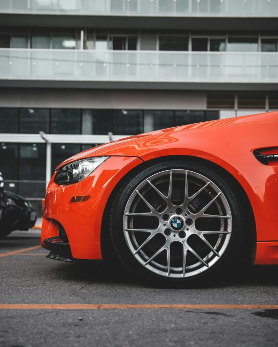 a orange car that is parked in a parking lot