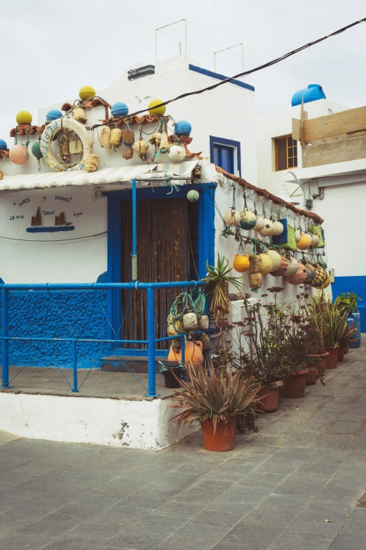 a blue and white building with a balcony in front of it