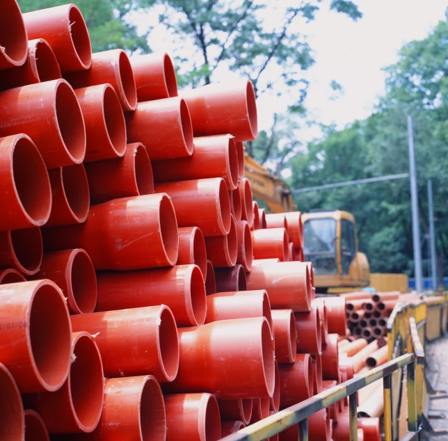 many pipes stacked up in a large pile