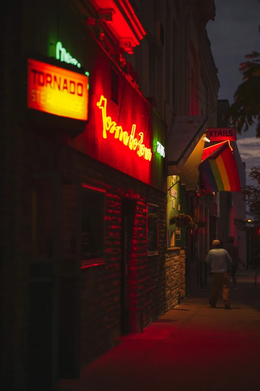 the side of a bar lit up at night