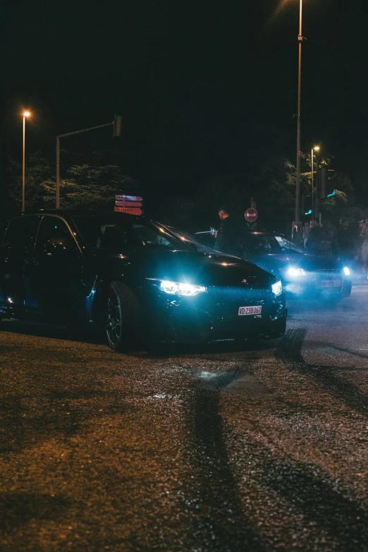 a car passing through a street light at night