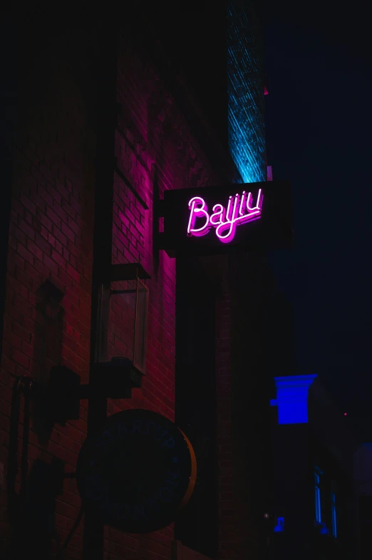 bright neon signs lit up against a dark background