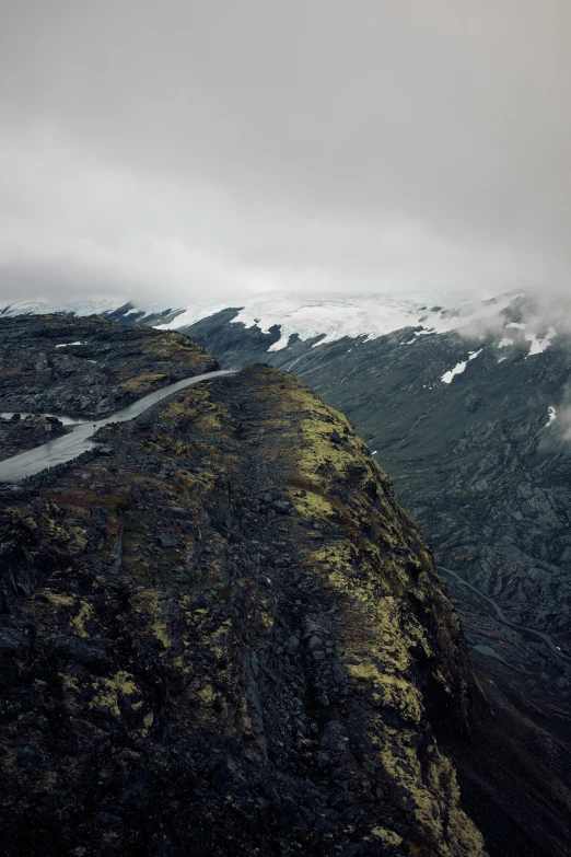 a man standing on the side of a cliff