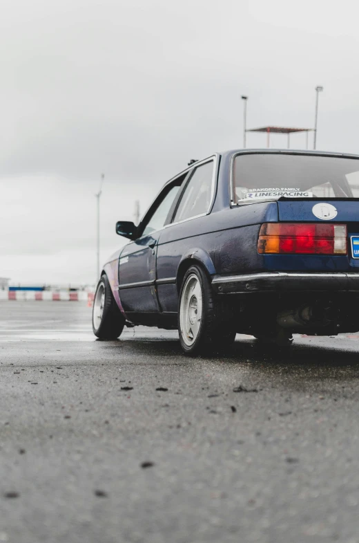 an older model car parked near a parking lot