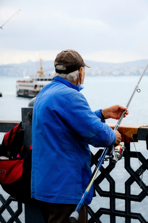 an older man is fishing on a pier