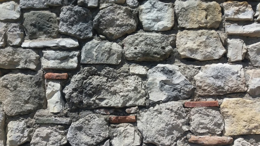 a brick wall with stones embedded into it