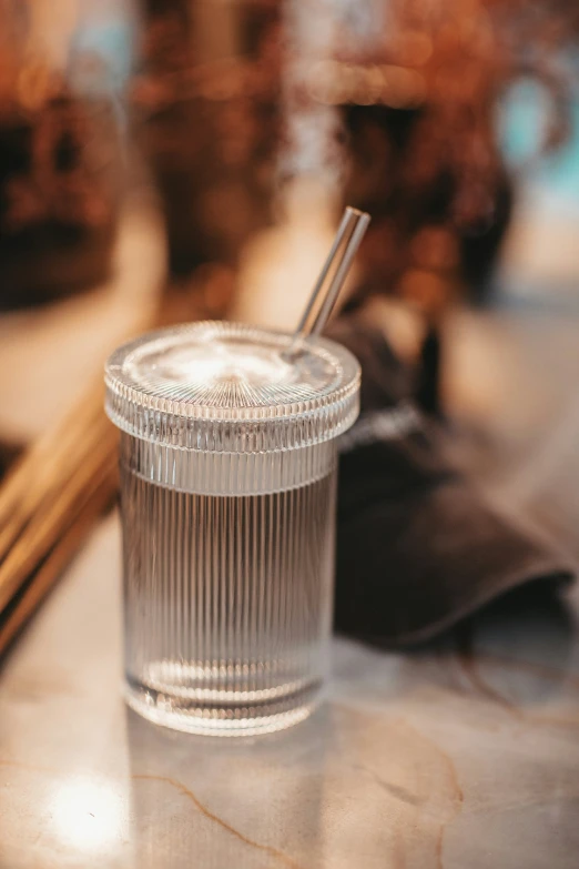 glass of water and sticks next to the mirror