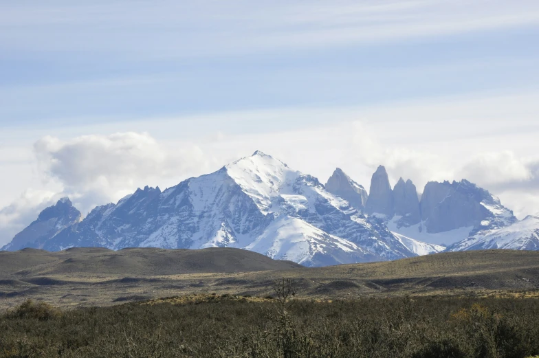 a view of a mountain with trees and shrubs around