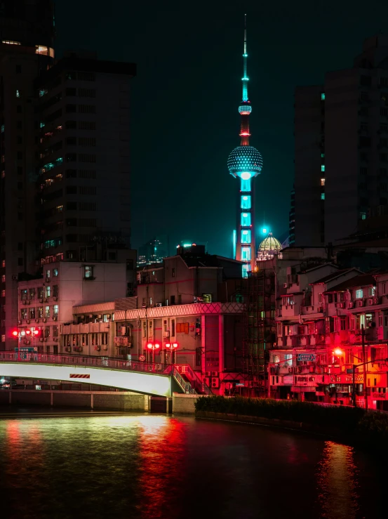 a large tower with a clock on top of it in the night