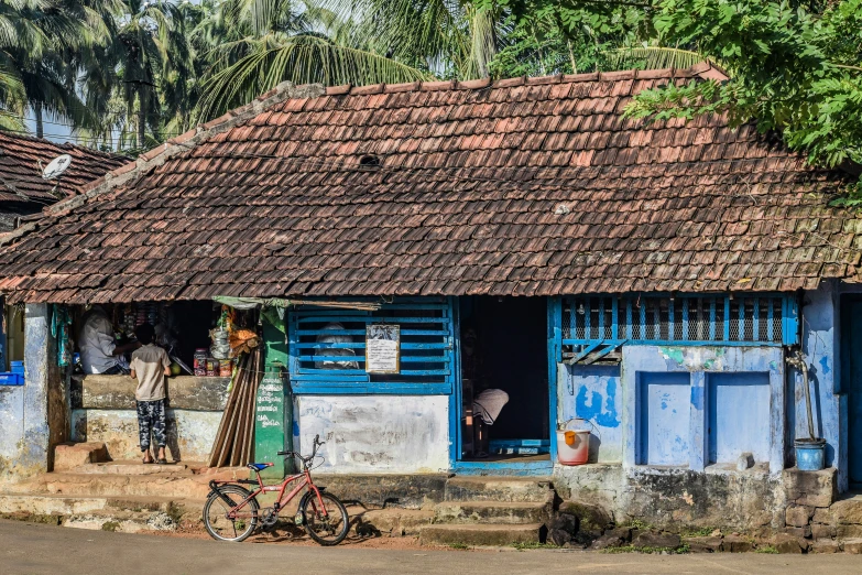 two blue houses and two bicycles are outside