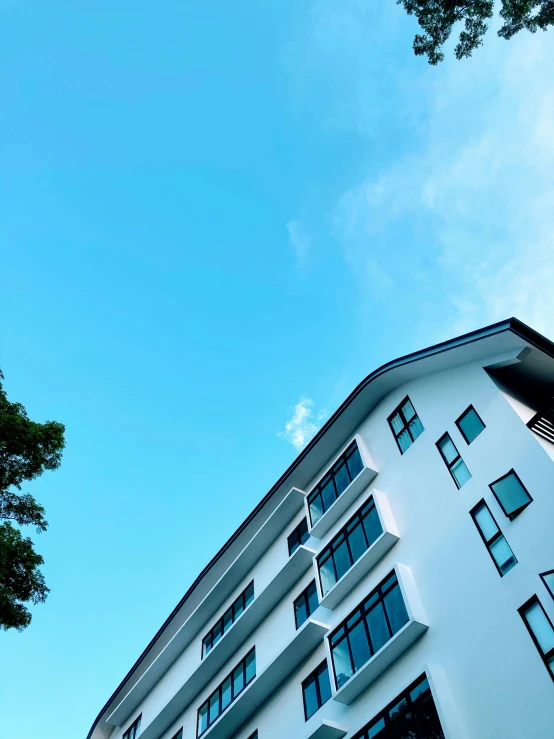 an upward view of some buildings and trees