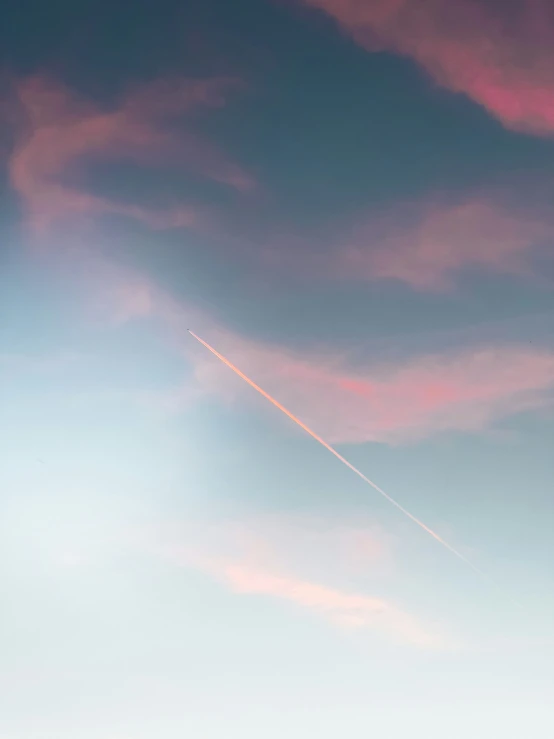 an airplane flying across a blue sky