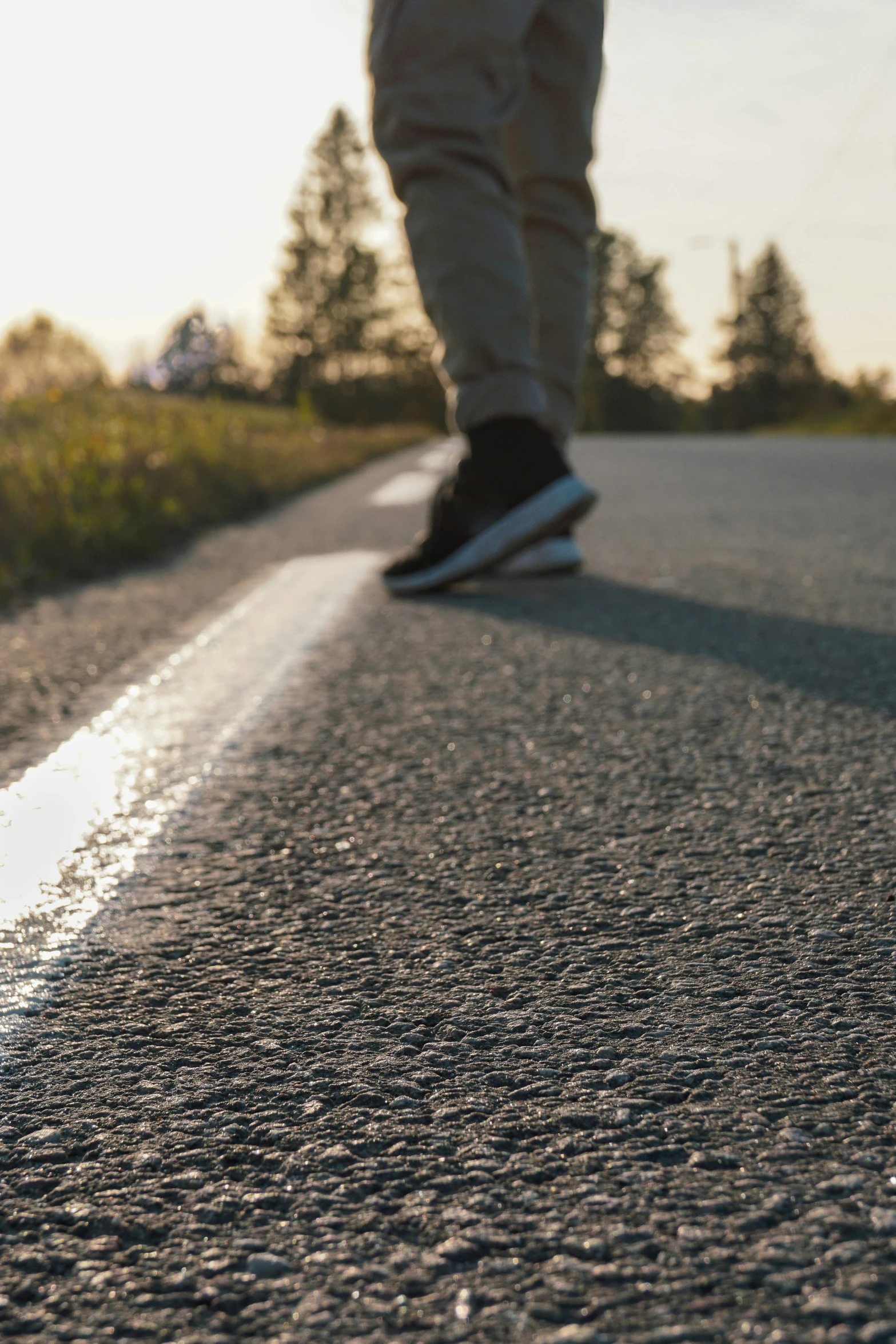 person in black and white shoes walking down street