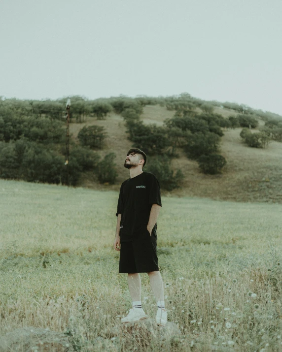 a man stands alone in an empty field