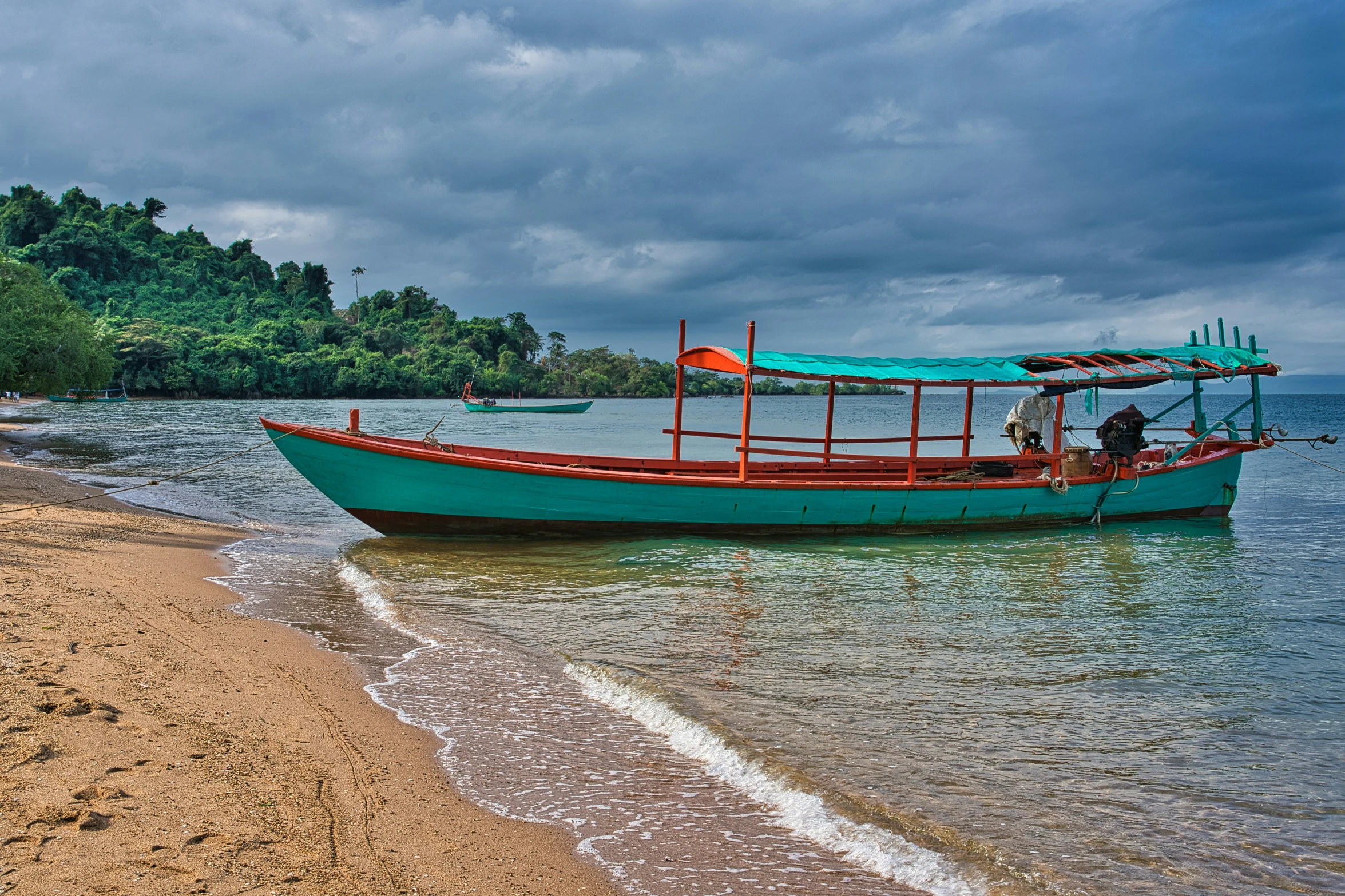 a blue boat floating on top of a body of water