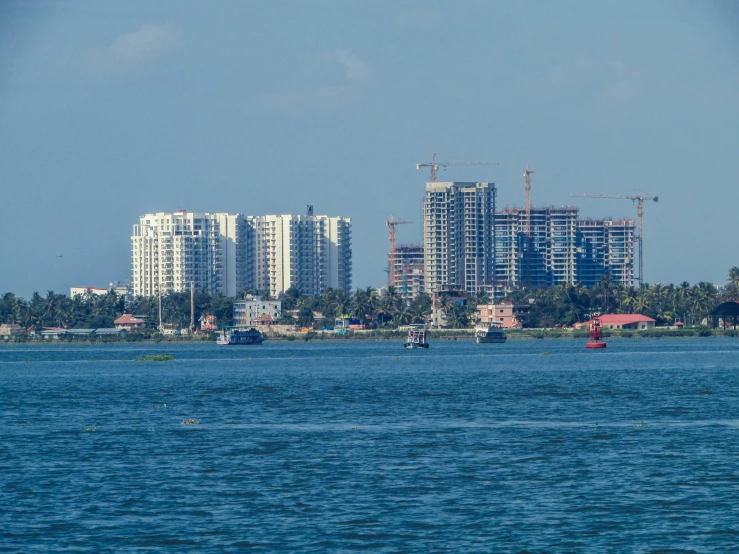 a city is shown behind the water with boats