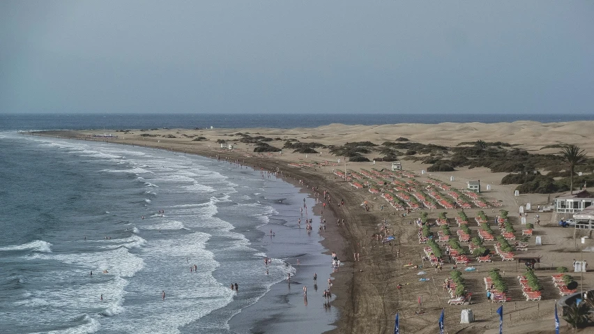 a group of umbrellas on the beach next to the ocean