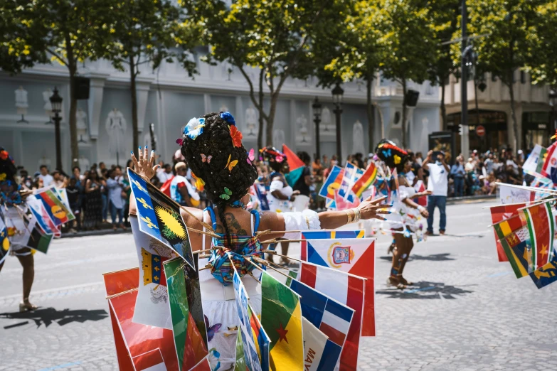 women in traditional costumes dancing with flags and confetti