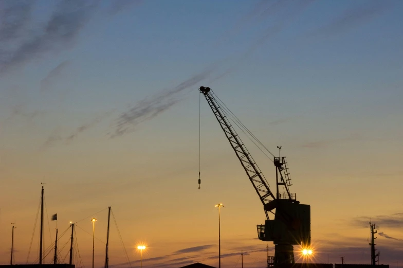 a crane is standing near many lights and other buildings