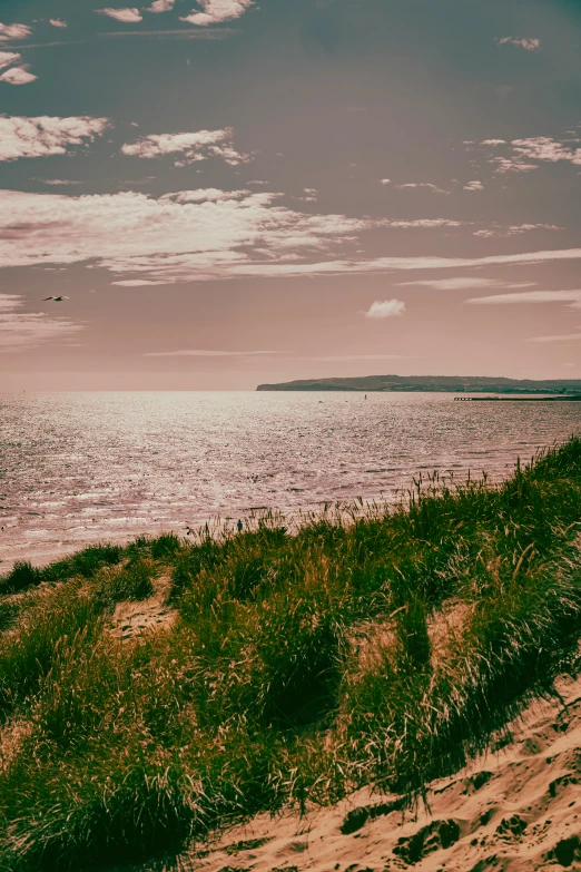 an overcast day at the beach with the sky and the water