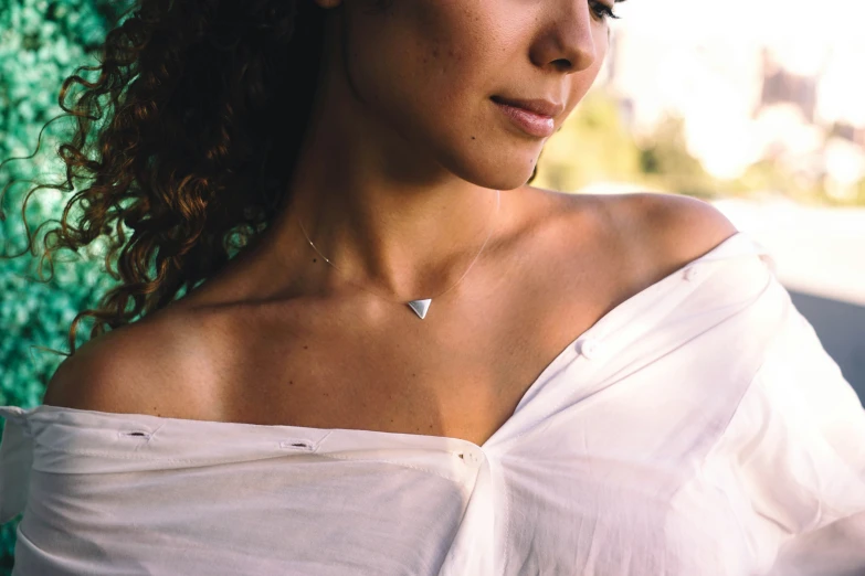 a woman with long hair in a off the shoulder top