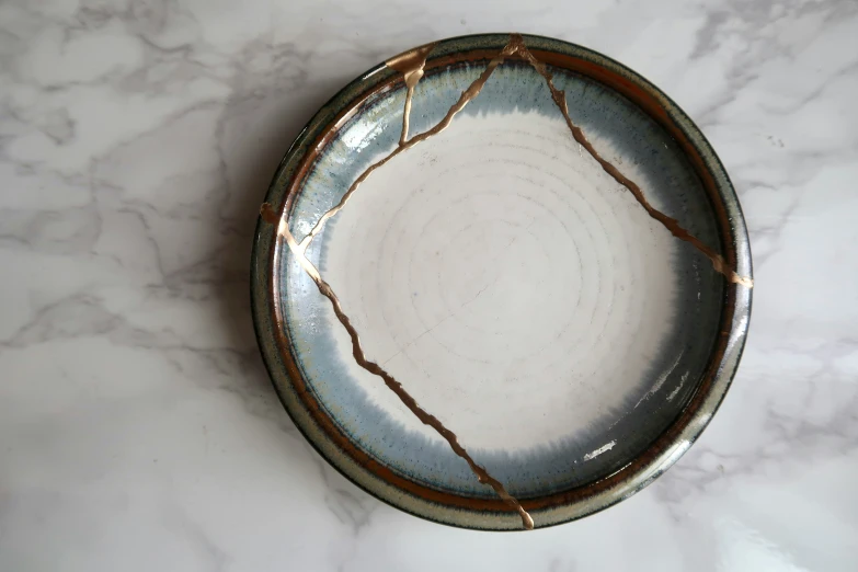 an oval blue and white plate sits on the floor