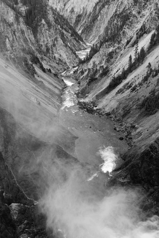 a view looking down at the river and mountains