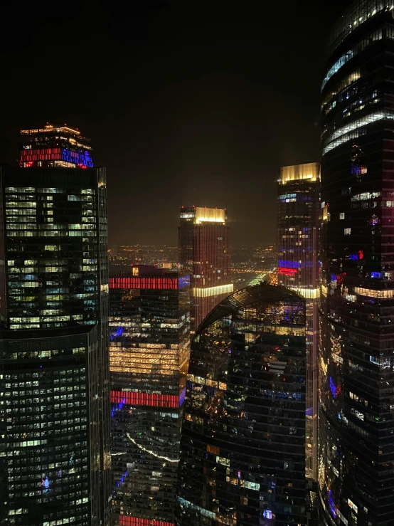 a city at night has a bunch of large buildings lit up