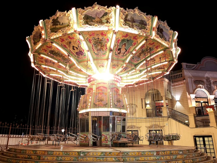 a carousel lit up at night with its lights on