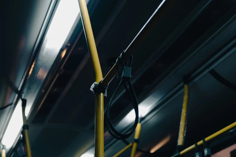 yellow pole holding electrical equipment inside a subway train