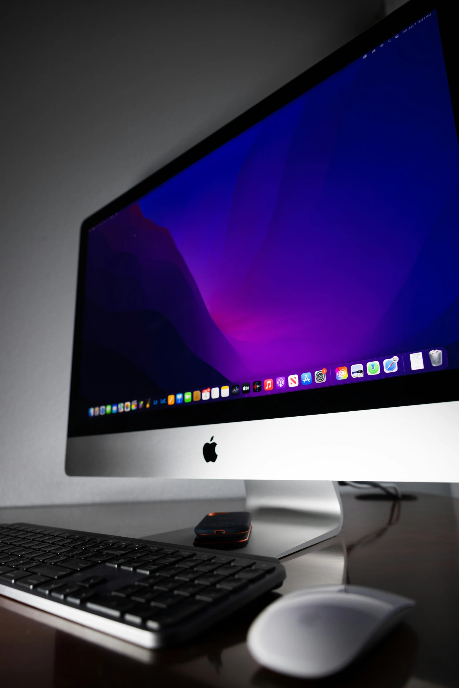 a computer monitor and mouse on top of a desk