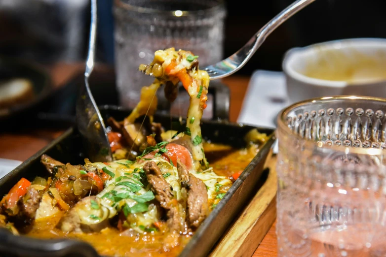 someone is serving food from a dish in a pan