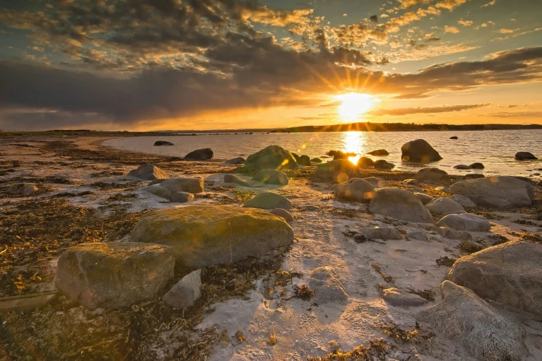 a po taken at the sunset on a rocky shoreline