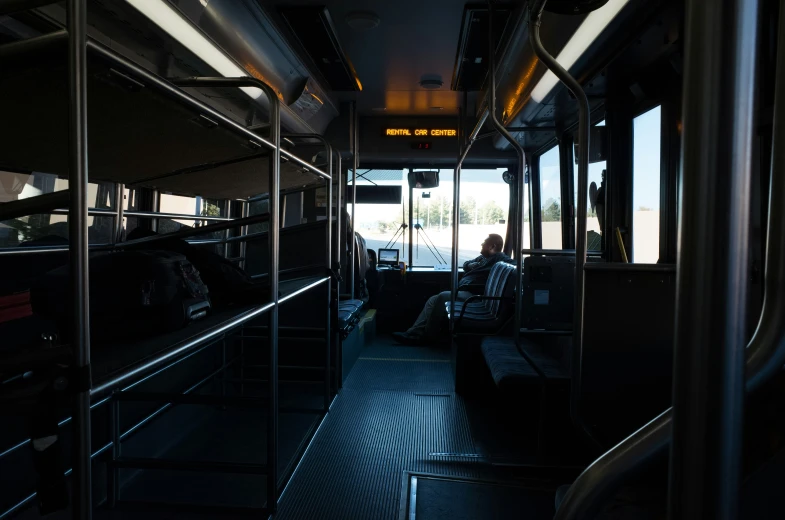 the inside of a large bus with people on it