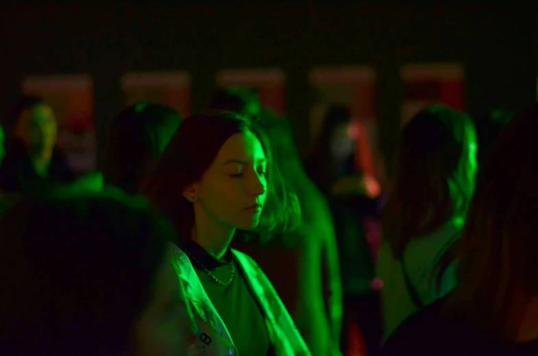 woman in a crowd with her head turned towards the side