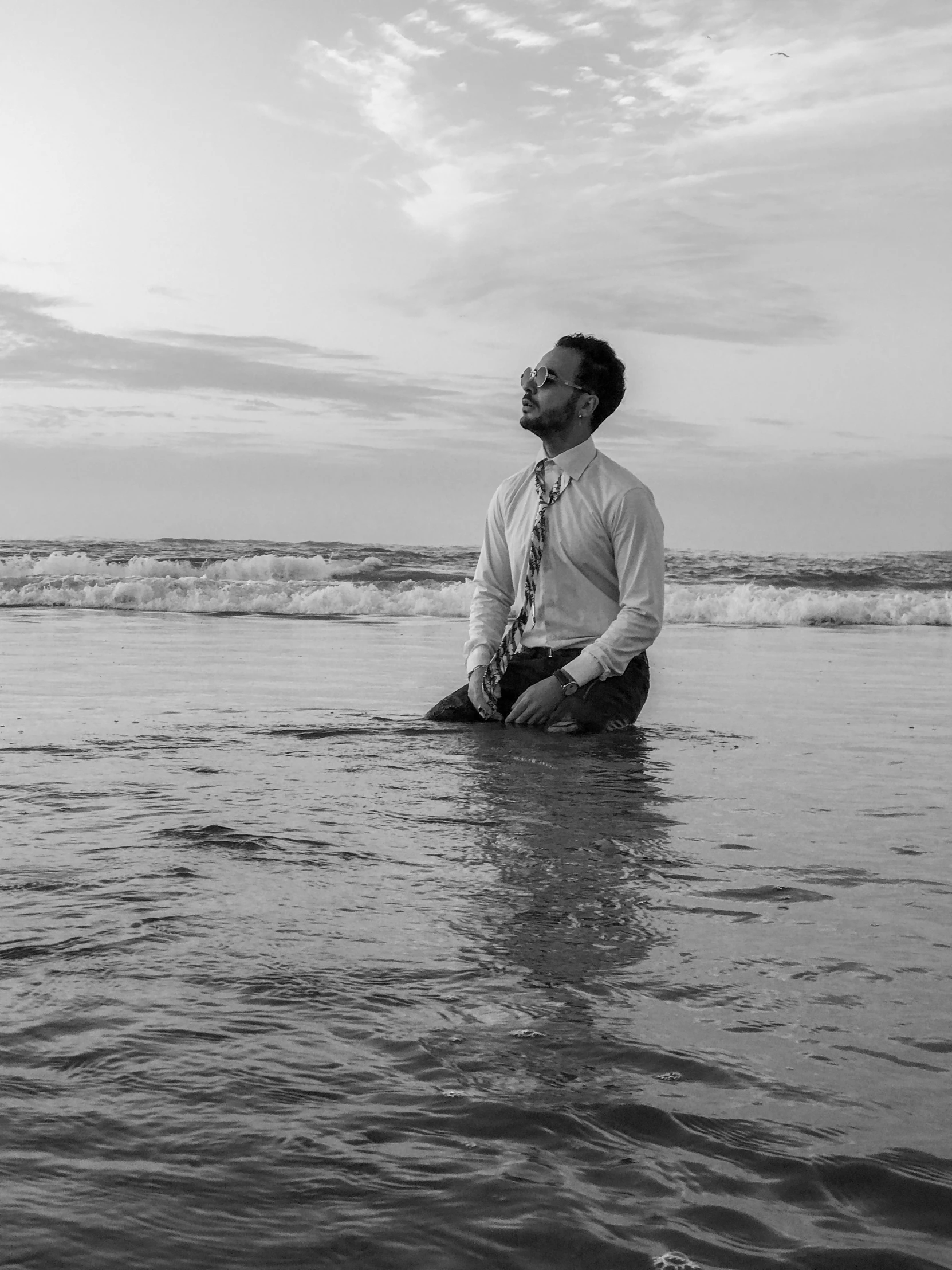 a man in tie sitting on the water