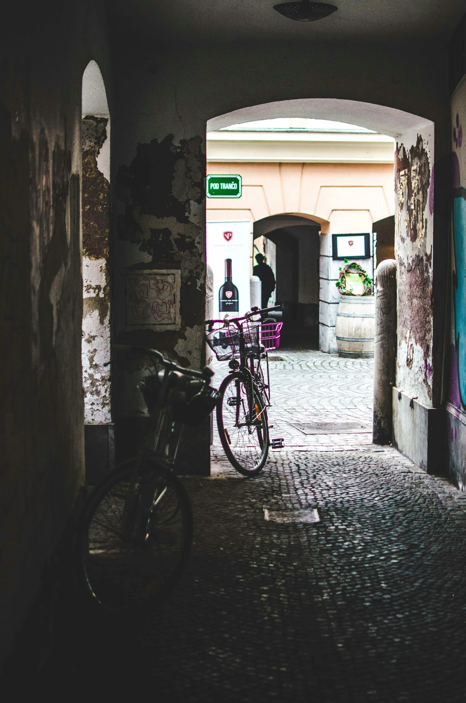 there is a bicycle parked in an alley