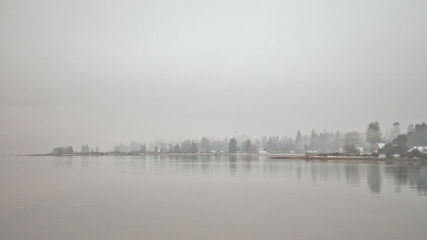 a lake with small houses and boats in the middle of it