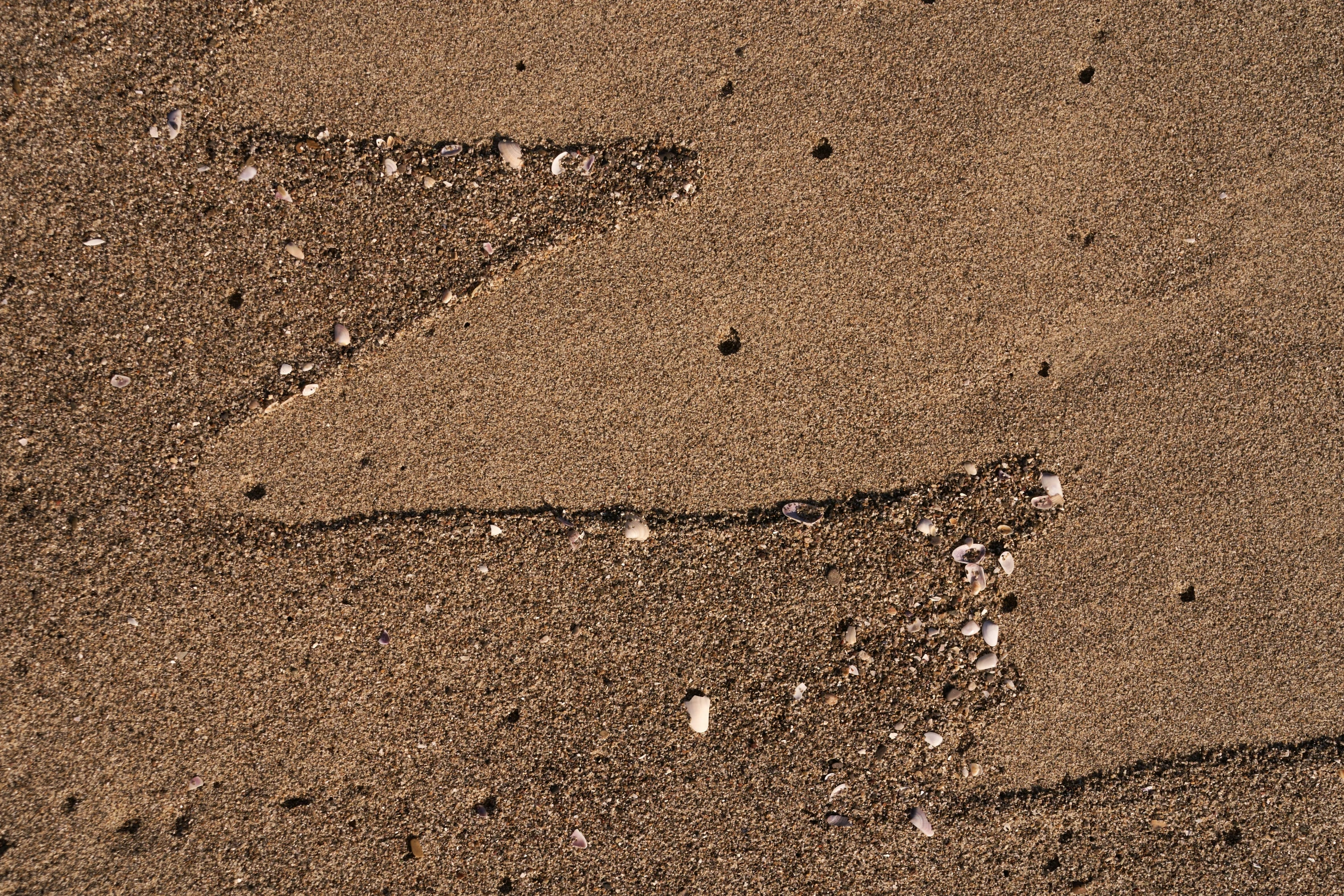 a number in the sand with rocks underneath it