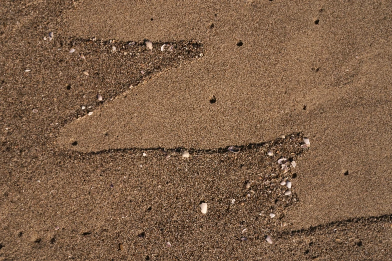 a number in the sand with rocks underneath it