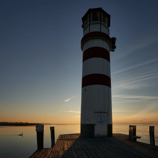 a light house at the end of a pier