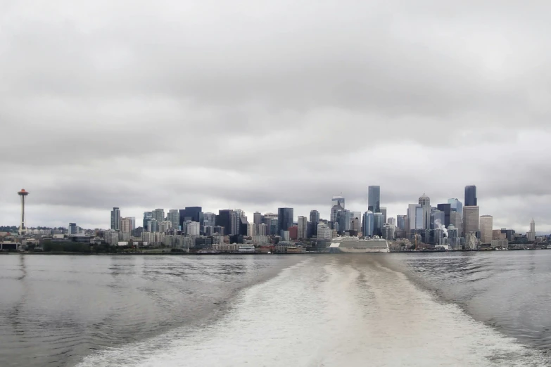 a boat travels on the river past a city