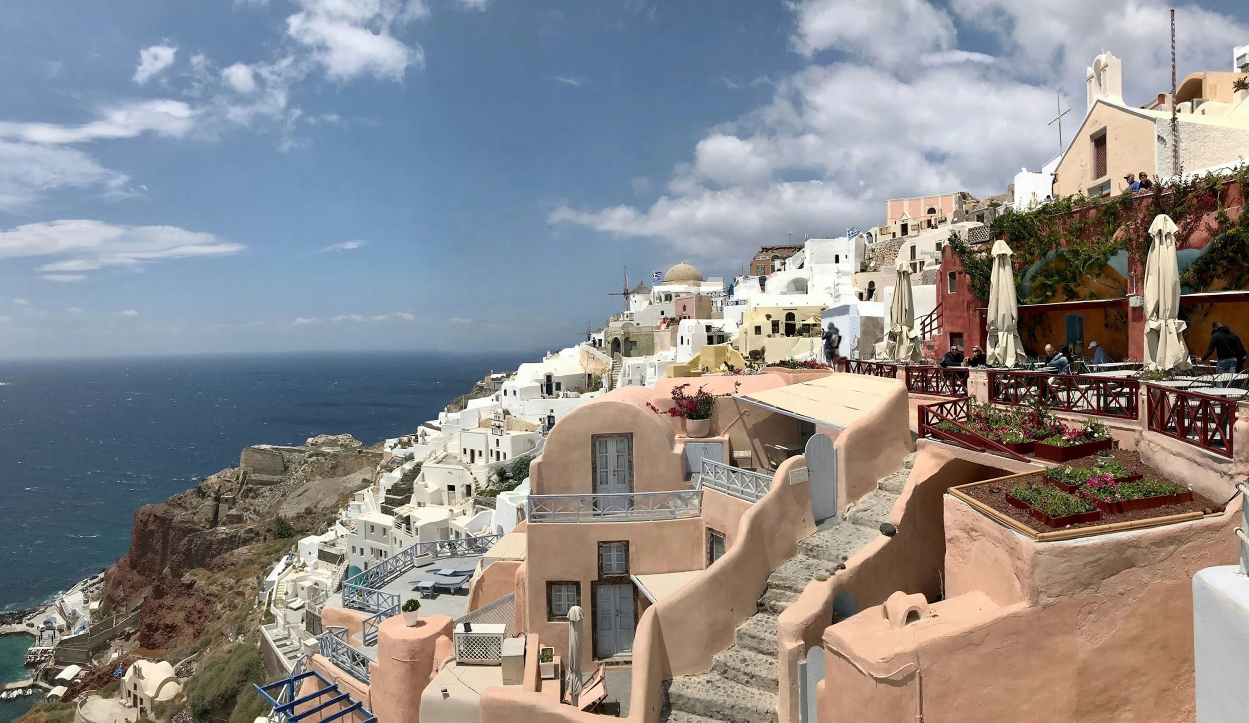 the seafront is near many buildings that look like they have been built on the cliff